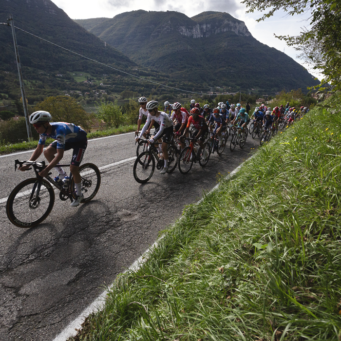 Il Lombardia 2024 - The peloton climbs in front of hills in Dosso