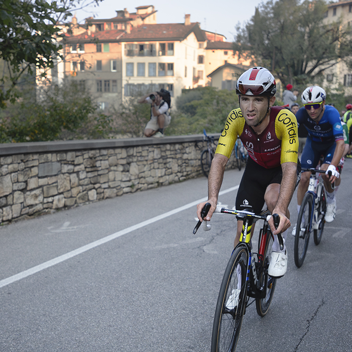 Il Lombardia 2025 - Benjamin Thomas of Cofidis, sunglasses tucked into his helmet, as he tackles the climb