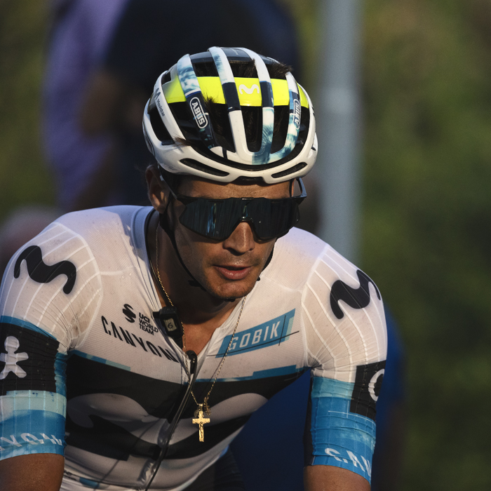 Il Lombardia 2025 - Javier Romo of Movistar Team his crucifix necklace glinting in the late afternoon sunlight as he climbs the hill