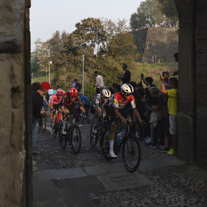 Il Lombardia 2025 - Riders are encouraged by supporters as they pass through the Porta San Lorenzo