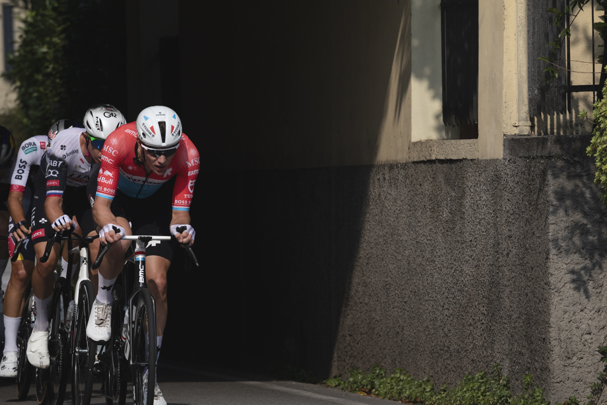 Il Lombardia 2025 - Luxembourg champion Arthur Kluckers races out of deep shadow cast by a traditional Italian building
