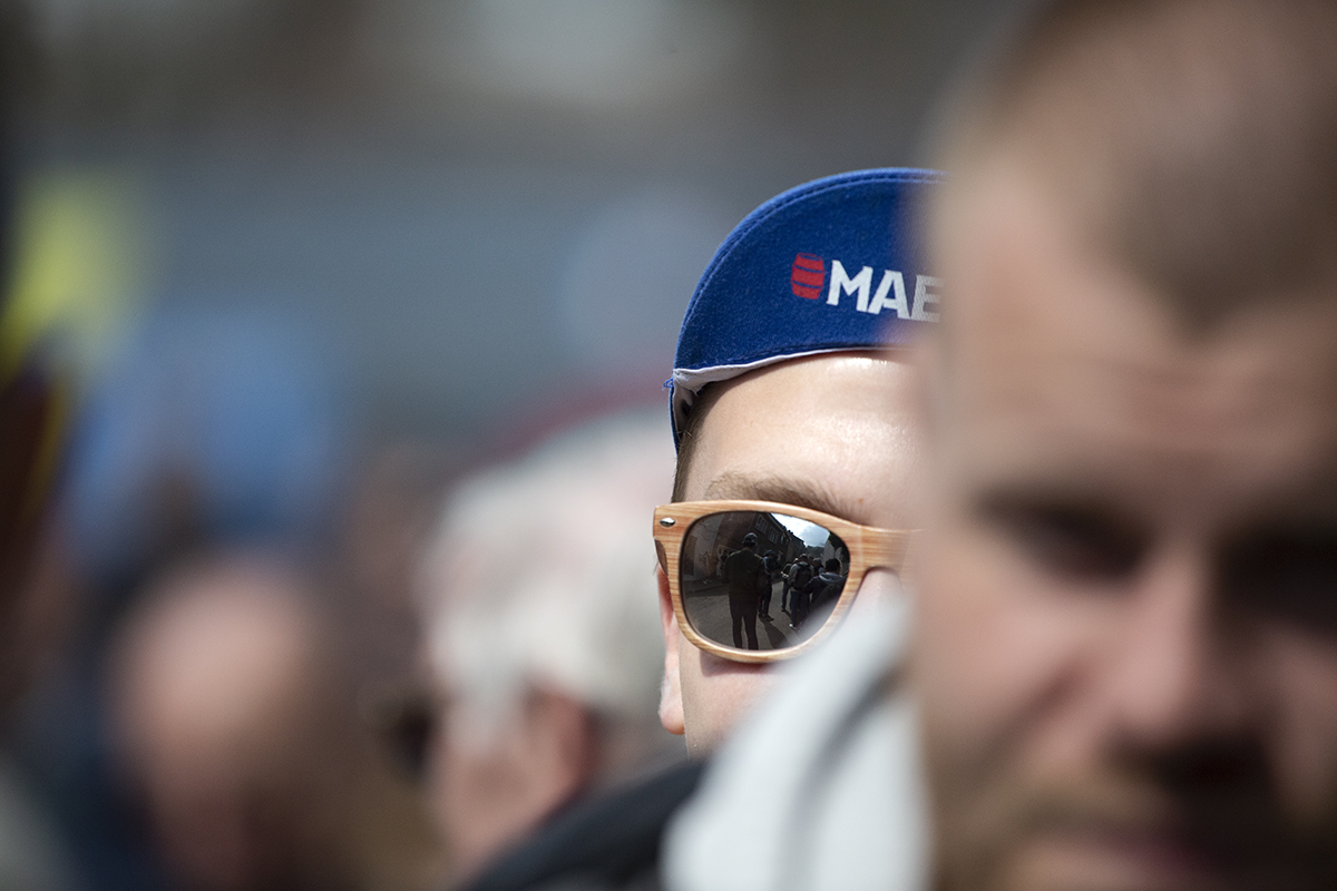 La Flèche Wallonne 2023 - Close up of a fan wearing cycling clothes and sunglasses with the Mur reflected in them