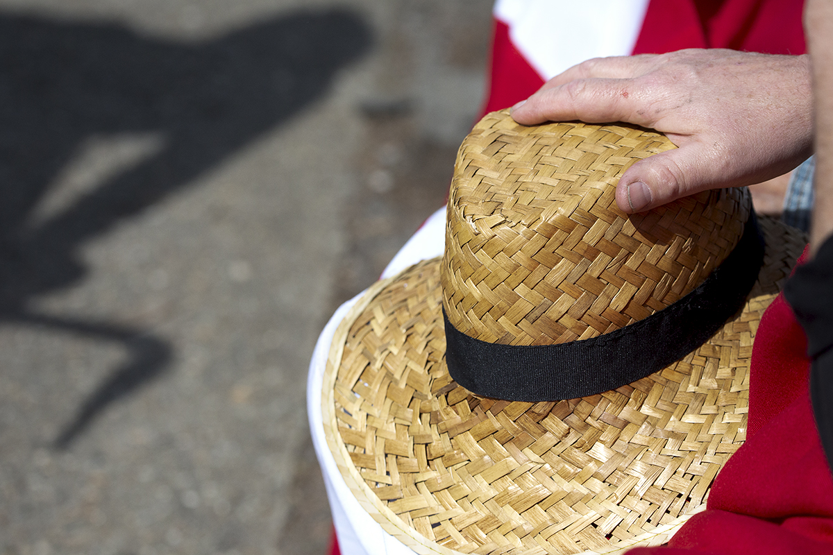 La Flèche Wallonne 2023 - A straw hat rests on a Danish Flag with a bike shadow on the road nearby