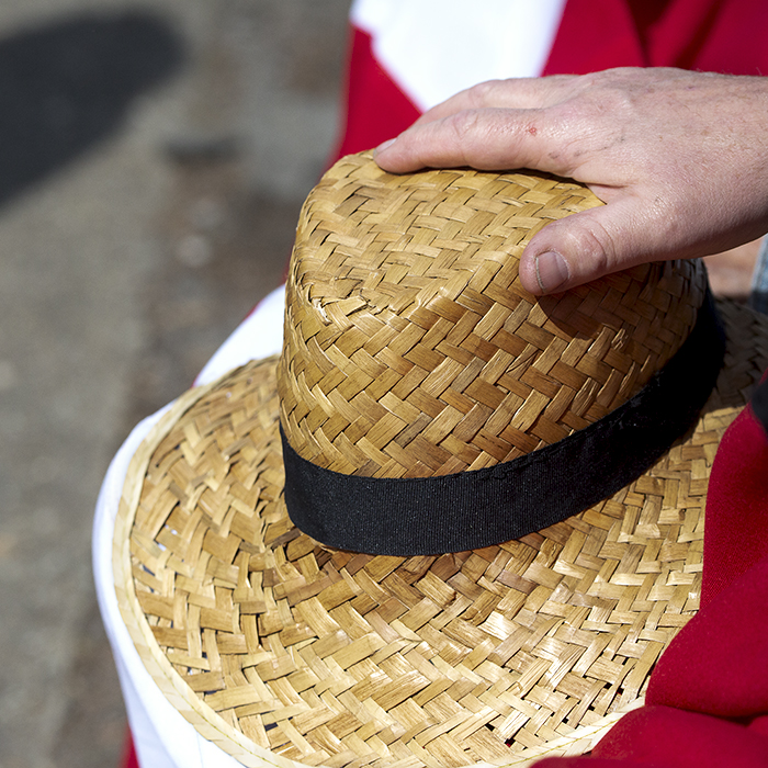 La Flèche Wallonne 2023 - A straw hat rests on a Danish Flag with a bike shadow on the road nearby