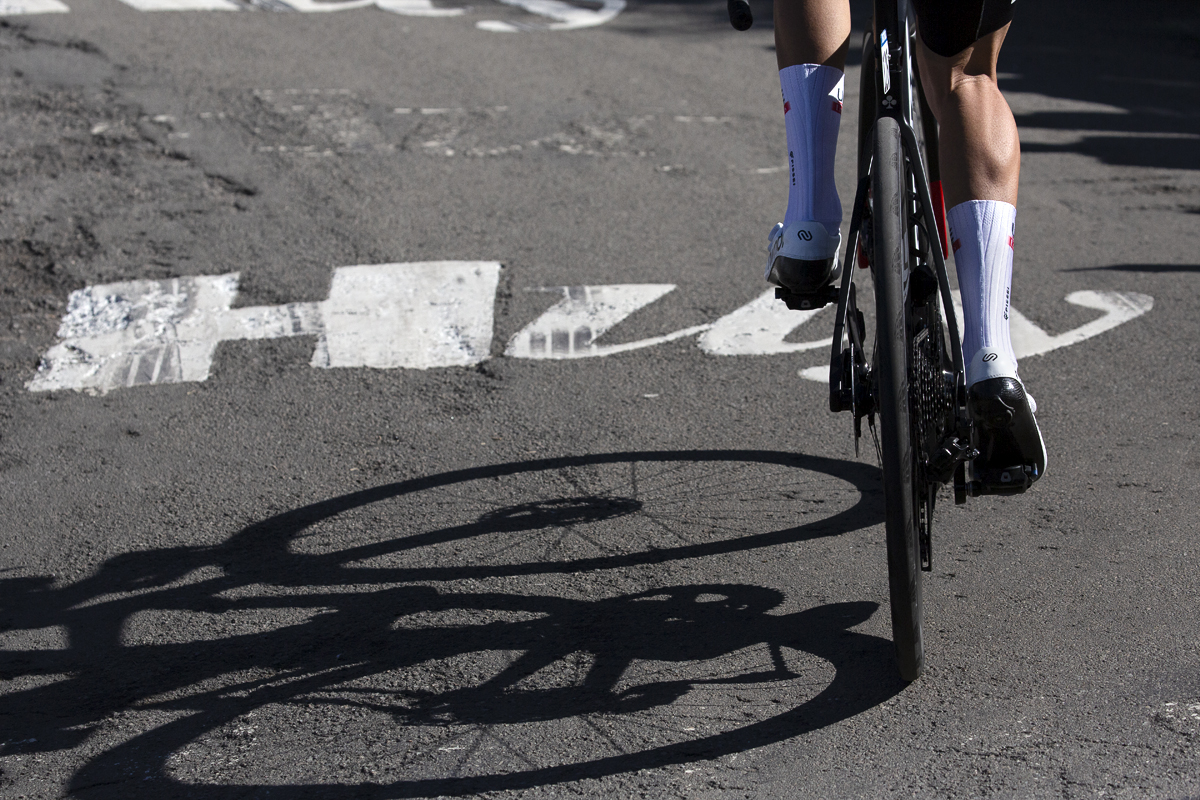 La Flèche Wallonne 2023 - Along the ascent of the Mur the word Huy is painted on the road with a bike shadow beneath to it