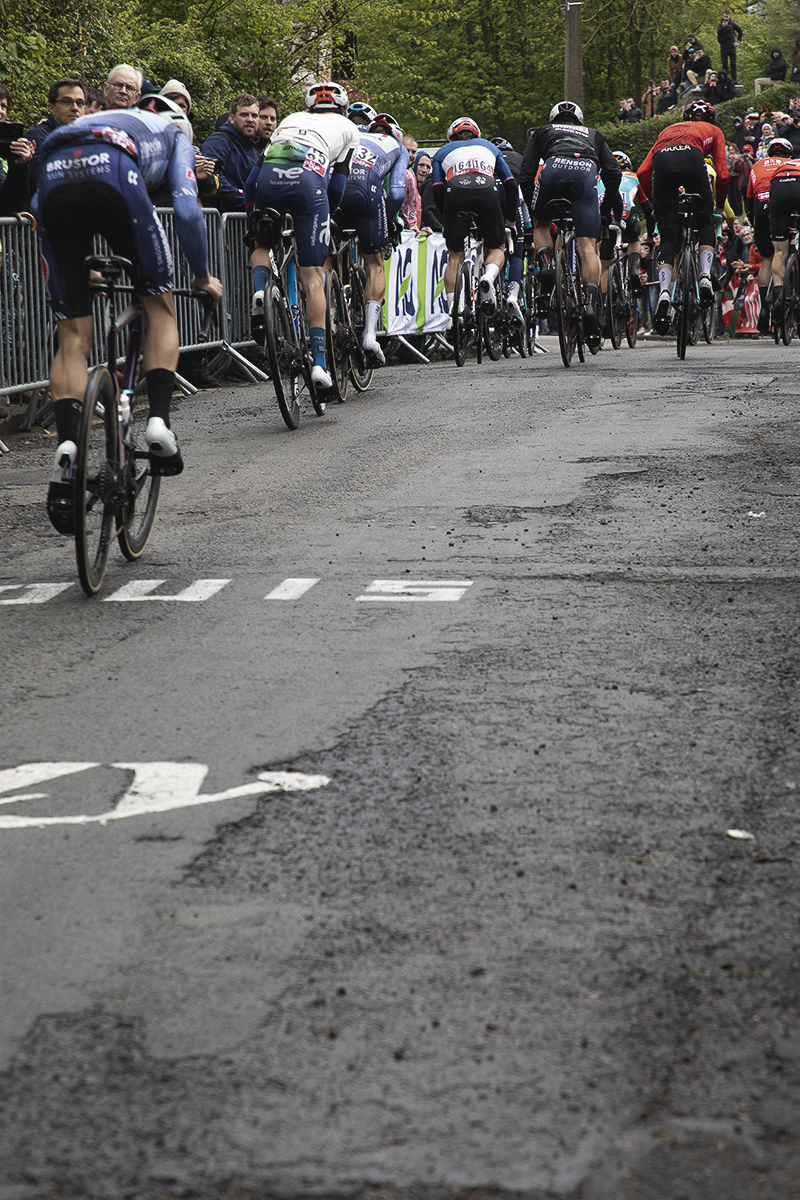 La Flèche Wallonne 2024 - A rear view of a group of riders ascending the Mur de Huy
