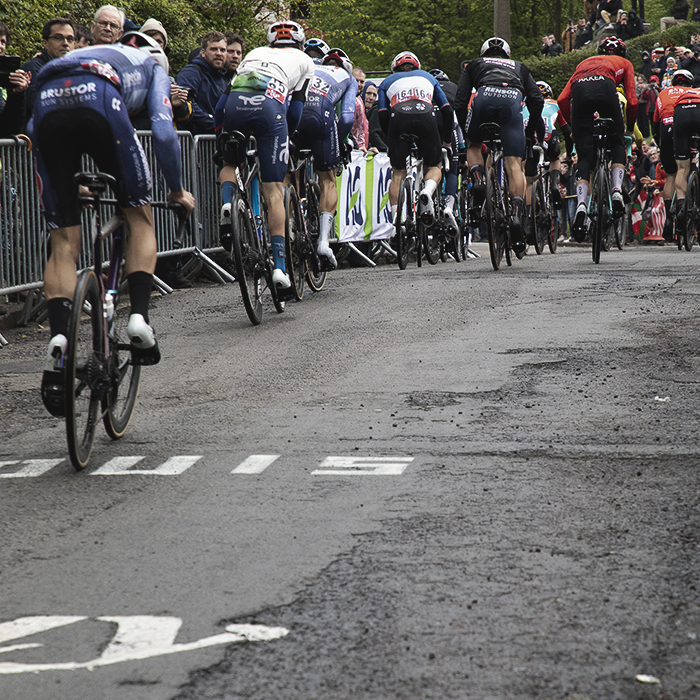 La Flèche Wallonne 2024 - A rear view of a group of riders ascending the Mur de Huy