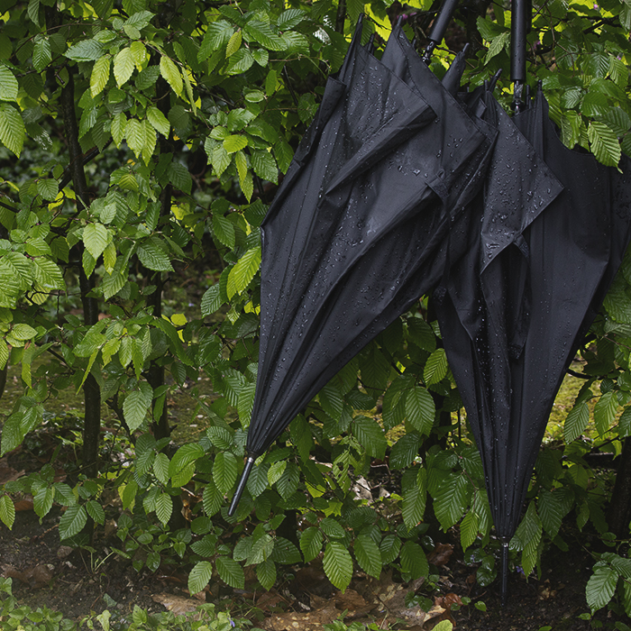 La Flèche Wallonne 2024 - Umbrellas hang from a hedge on the Mur de Huy
