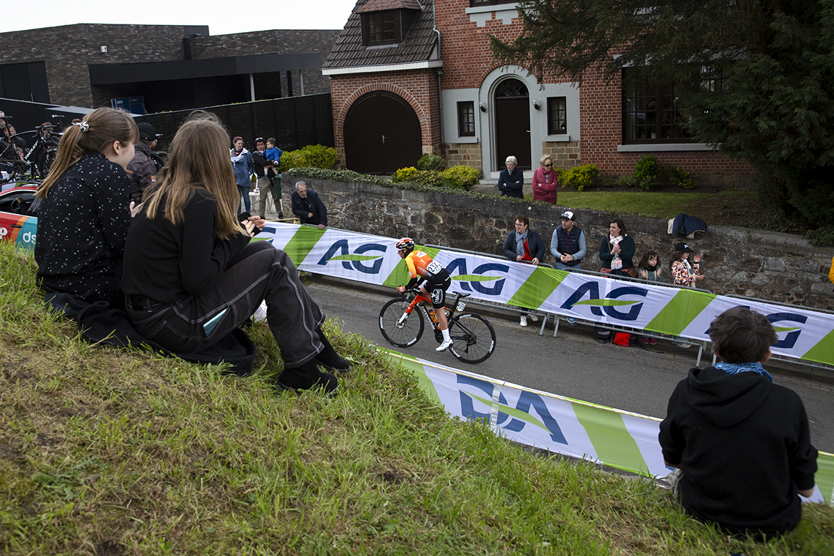 La Flèche Wallonne Femmes 2023 - Sandrine Bideau of St Michel - Mavic - Auber93 is framed by children watching the race from the Mur