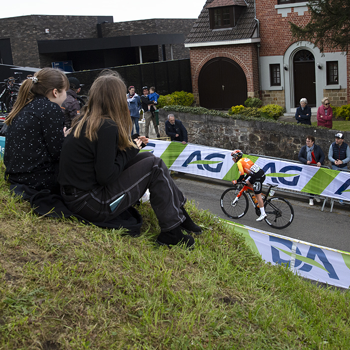 La Flèche Wallonne Femmes 2023 - Sandrine Bideau of St Michel - Mavic - Auber93 is framed by children watching the race from the Mur