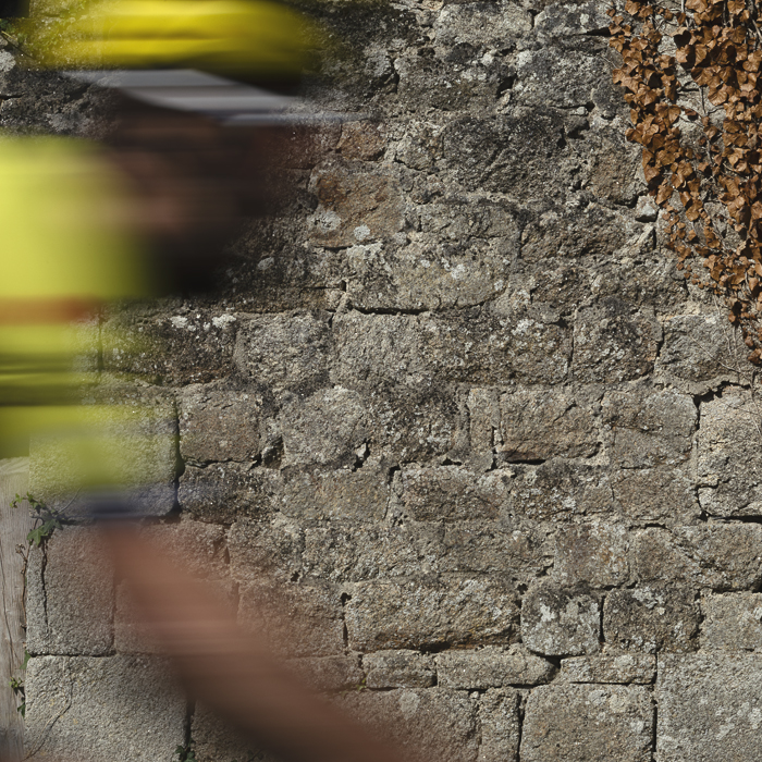Bretagne Classic - Ouest-France 2025 - An impression of a rider passing in front of a stone wall