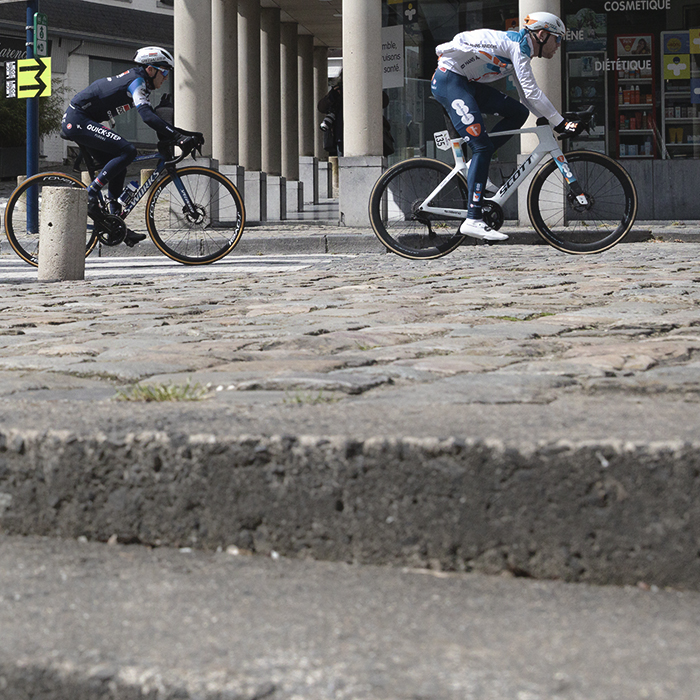 Liège-Bastogne-Liège 2024 - Riders viewed from street level looking up steps in Stavelot