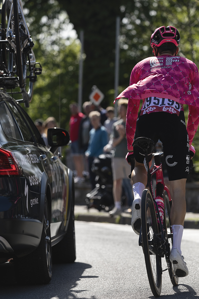 Liege Bastogne Liege 2025 - Neilson Powless stamps on the pedals as he makes his way through the race convoy