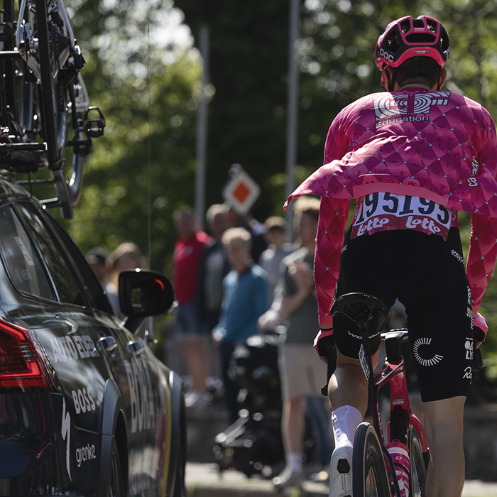Liege Bastogne Liege 2025 - Neilson Powless stamps on the pedals as he makes his way through the race convoy