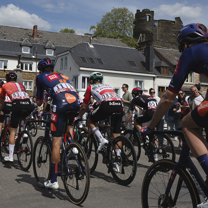 Liege Bastogne Liege 2025 - The peloton with the castle at La Roché-en-Ardenne in the background