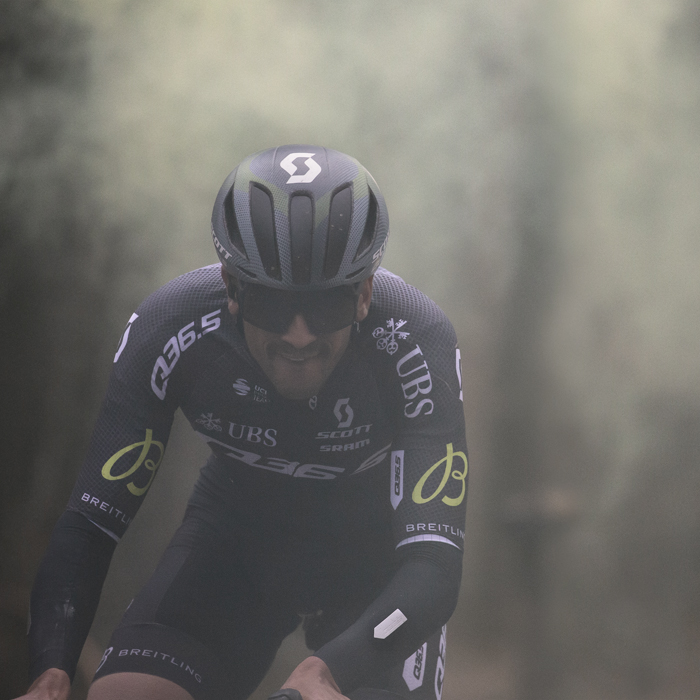 Omloop Het Nieuwsblad 2024 - Nicolò Parisini of Q36.5 Pro Cycling Team emerges from the smoke of a flare on Bosberg