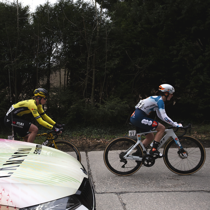 Omloop Het Nieuwsblad Vrouwen 2024 - Linda Riedmann of Team Visma - Lease a Bike & Francesca Barale of Team dsm-firmenich PostNL with a team car on Kapellestraat