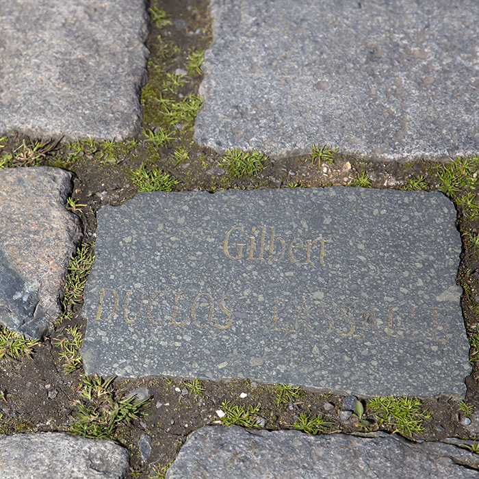 Paris Roubaix 2023 - Cobbles on the Wallers à Hélesmes sector showing the name of a benefactor