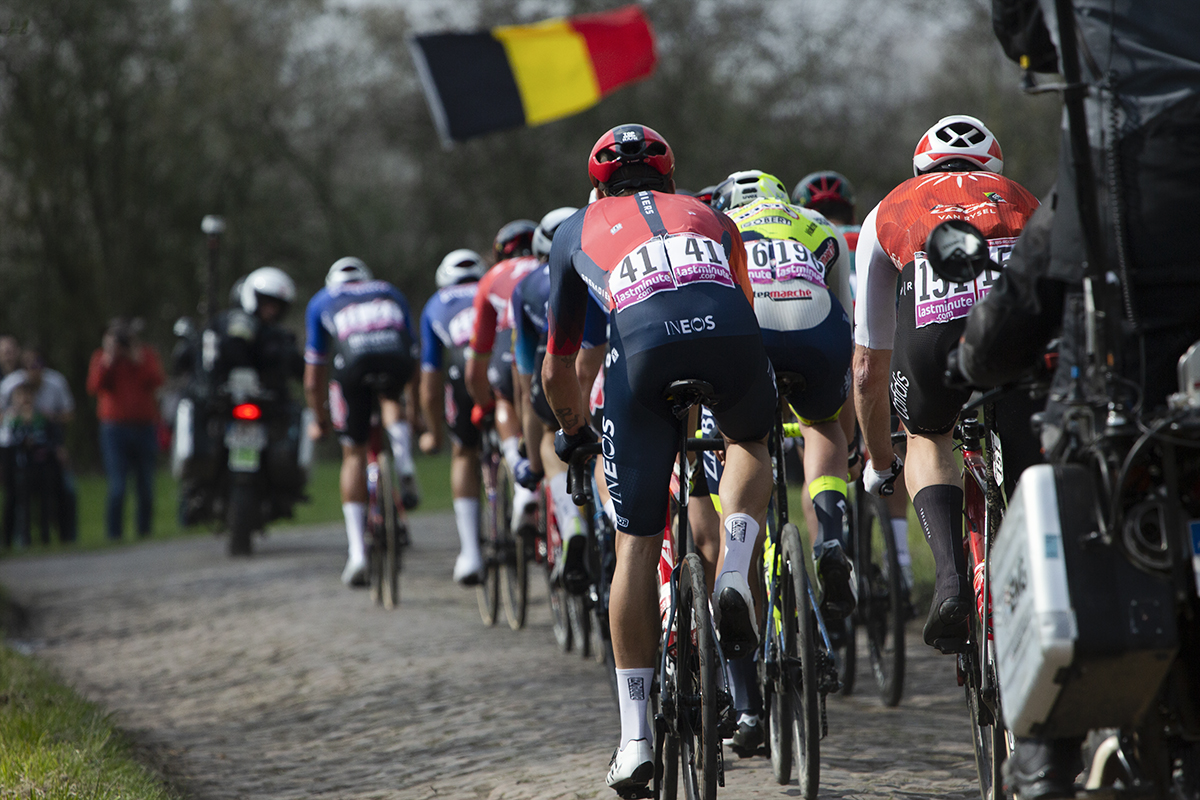 Paris Roubaix 2023 - A Belgian flag is waved as the riders move off the Wallers à Hélesmes cobbled sector