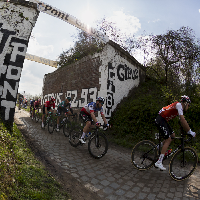 Paris Roubaix 2023 - A group of riders pass through Pont Gibus on the Wallers à Hélesmes sector