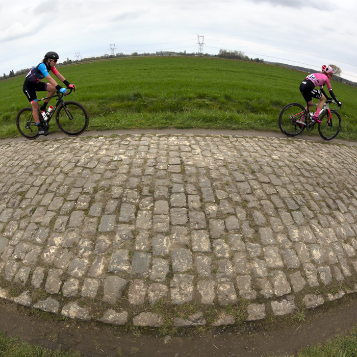 Paris Roubaix Femmes 2023 - A distorted shot of Sofie van Rooijen from Parkhotel Valkenburg and EF Education-TIBCO-SVB’s Lauren Stephens riding across the flat landscape