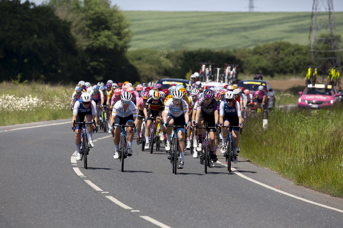 RideLondon Classique 2022 - The peloton approaches round a sweeping bend