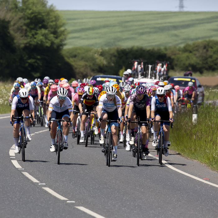 RideLondon Classique 2022 - The peloton approaches round a sweeping bend