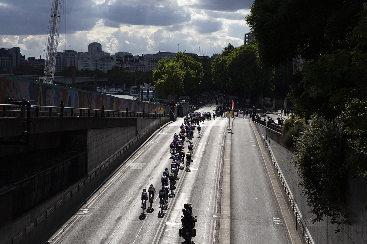 RideLondon Classique 2022 - A silhouetted peolton emerge from Blackfriars Underpass