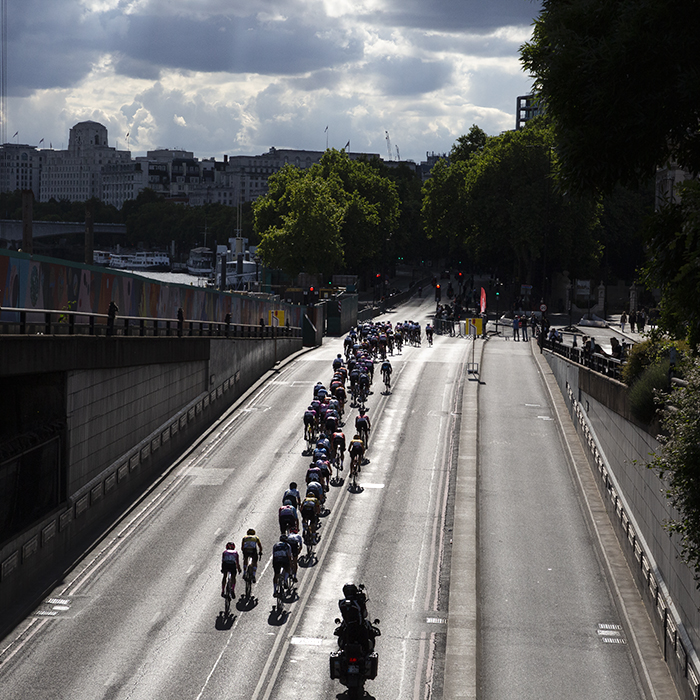 RideLondon Classique 2022 - A silhouetted peolton emerge from Blackfriars Underpass