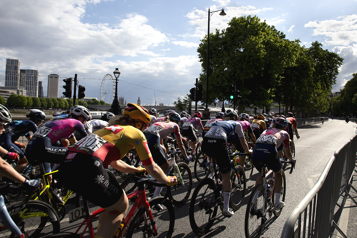 RideLondon Classique 2022 - The peloton ride down The Embankment with the London Eye in the background 