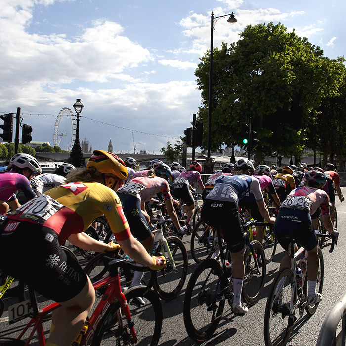 RideLondon Classique 2022 - The peloton ride down The Embankment with the London Eye in the background 