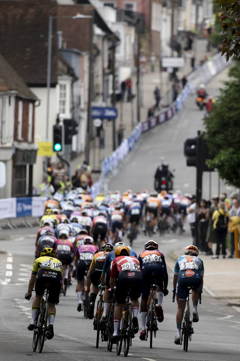 RideLondon Classique 2024 - The peloton seen just before the steep road of the final climb in Colchester