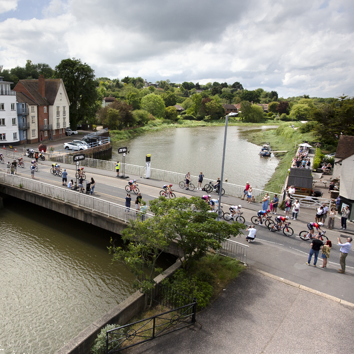 RideLondon Classique 2024 - Riders cross a bridge over the river in Maldon