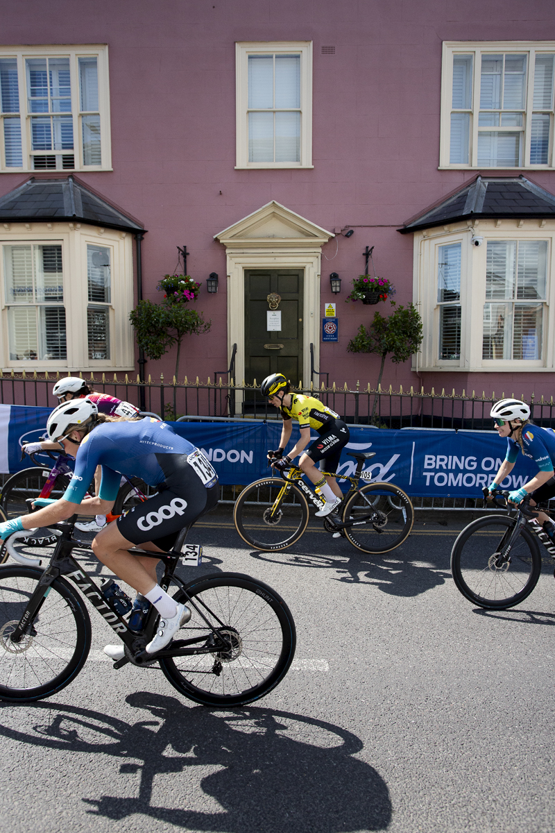 RideLondon Classique 2024 - Riders pass a pink house on Market Hill in Maldon