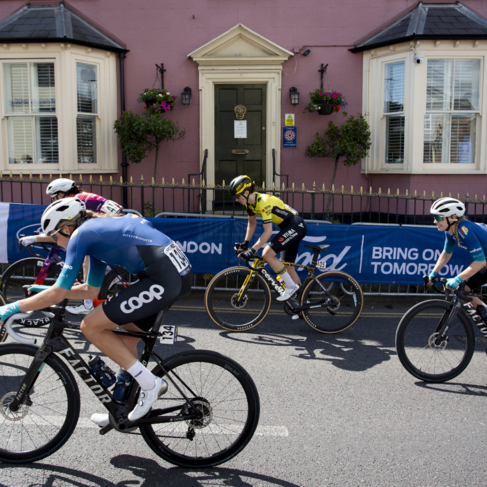 RideLondon Classique 2024 - Riders pass a pink house on Market Hill in Maldon