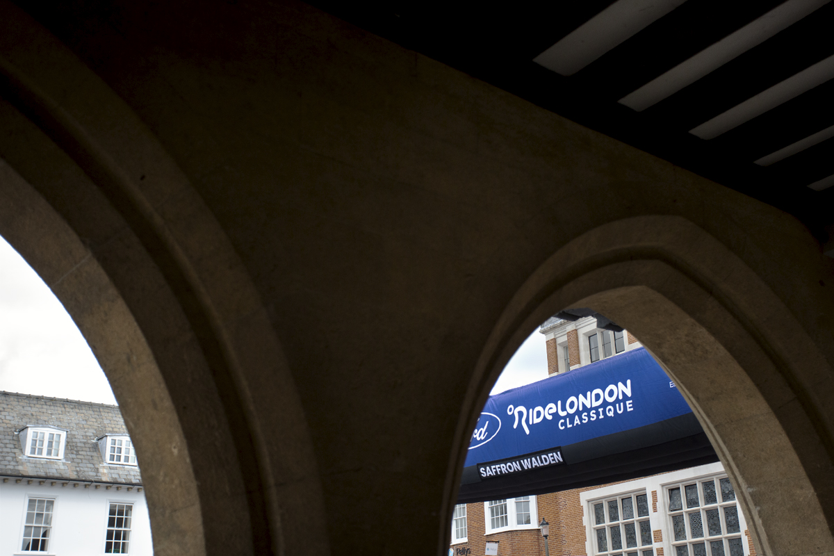 RideLondon Classique 2024 - The race start gate seen through a stone arch in Saffron Waldon