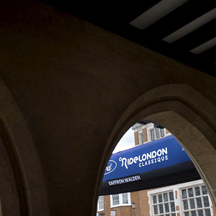 RideLondon Classique 2024 - The race start gate seen through a stone arch in Saffron Waldon