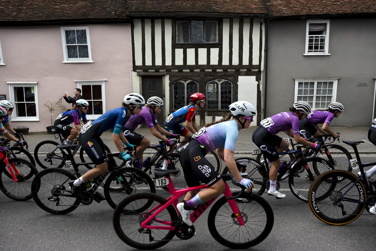 RideLondon Classique 2024 - Riders pass a traditional black and white timbered building in Thaxted