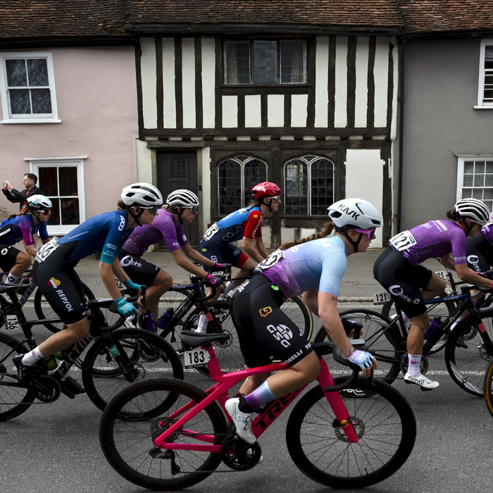 RideLondon Classique 2024 - Riders pass a traditional black and white timbered building in Thaxted