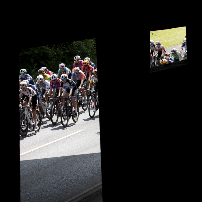 RideLondon Classique 2024 - Riders are framed by the supports of a concrete bridge in Witham