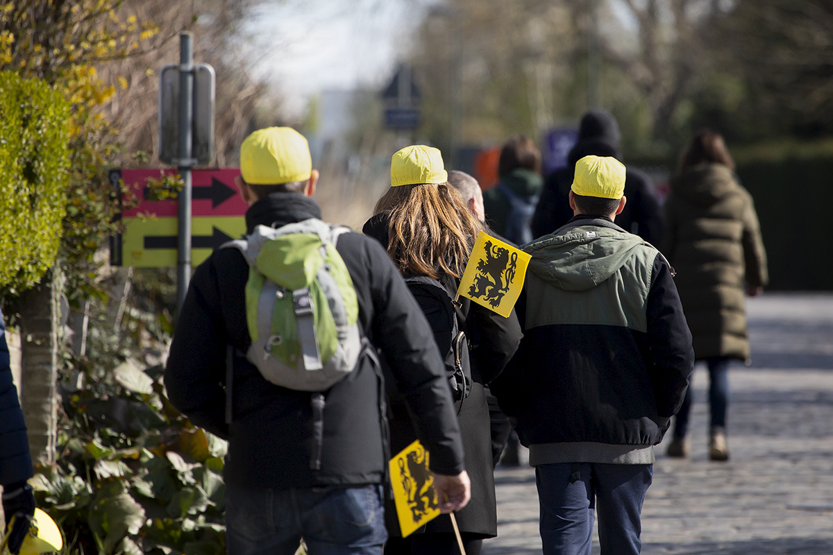 Ronde van Vlaanderen 2022 - Fans with Flanders flags in their hands and bags make their way to their vantage points in preparation for the race