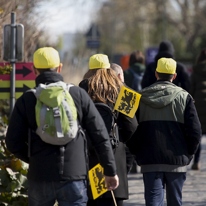 Ronde van Vlaanderen 2022 - Fans with Flanders flags in their hands and bags make their way to their vantage points in preparation for the race