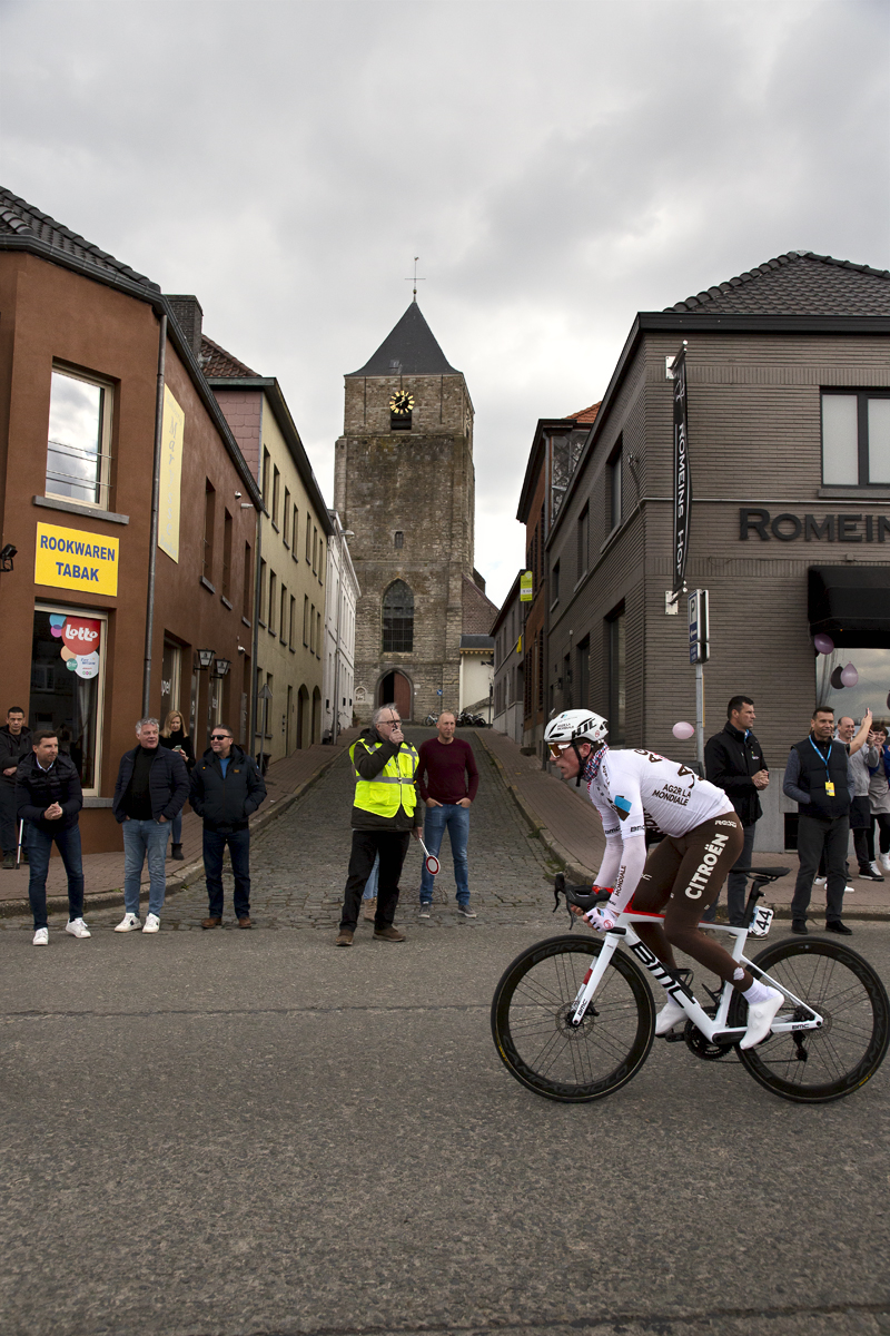 Ronde van Vlaanderen 2022 - Stan Dewulf of AG2R Citroën Team passes the church in Velzeke