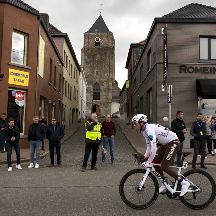 Ronde van Vlaanderen 2022 - Stan Dewulf of AG2R Citroën Team passes the church in Velzeke