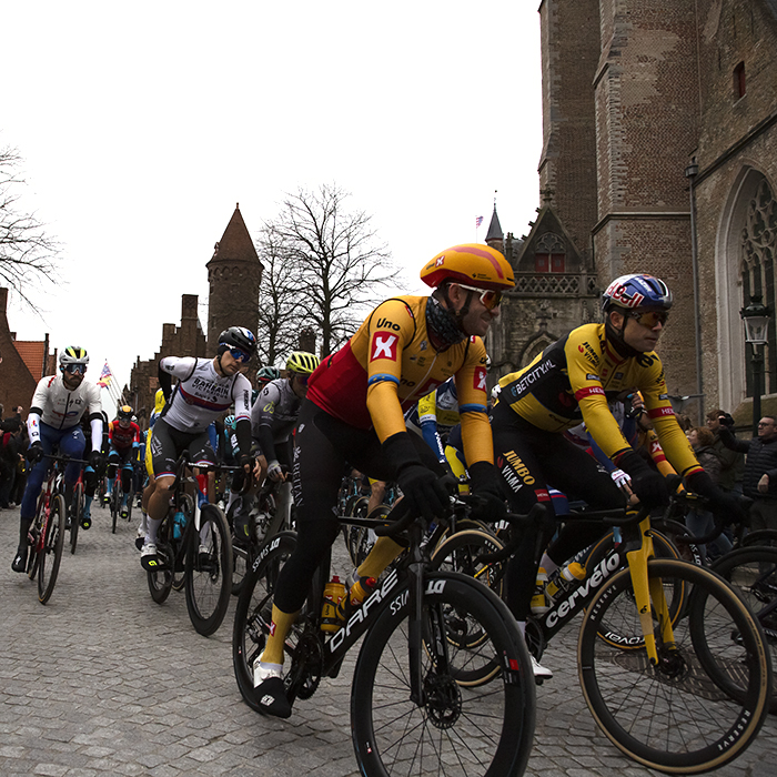 Ronde van Vlaanderen 2023 - Alexander Kristoff of Uno-X Pro Cycling Team and Wout van Aert of Jumbo-Visma lead the riders through the streets of Brugge