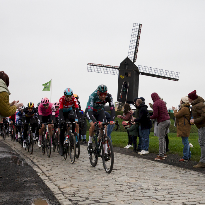 Ronde van Vlaanderen 2023 - Belgian fans lines the cobbled road of Huisepontweg as the race passes by the Schietsjampettermolen windmill