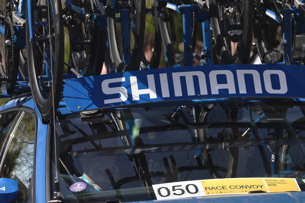 Ronde van Vlaanderen 2025 - Spare bikes are seen reflected in the windscreen of the Shimano Netural Service Vehicle