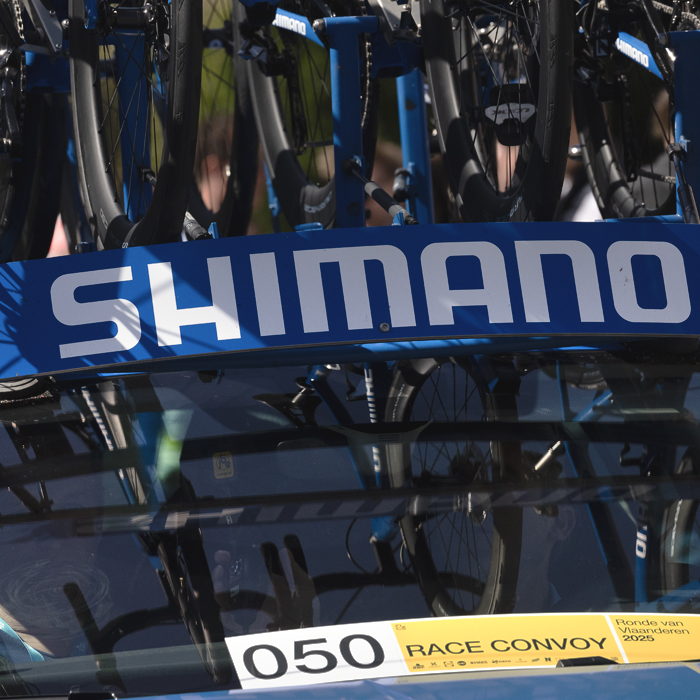 Ronde van Vlaanderen 2025 - Spare bikes are seen reflected in the windscreen of the Shimano Netural Service Vehicle