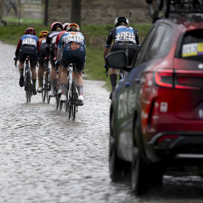 Ronde van Vlaanderen Vrouwen 2024 - Riders seen moving away down Mariaborrestraat followed by one of the team cars