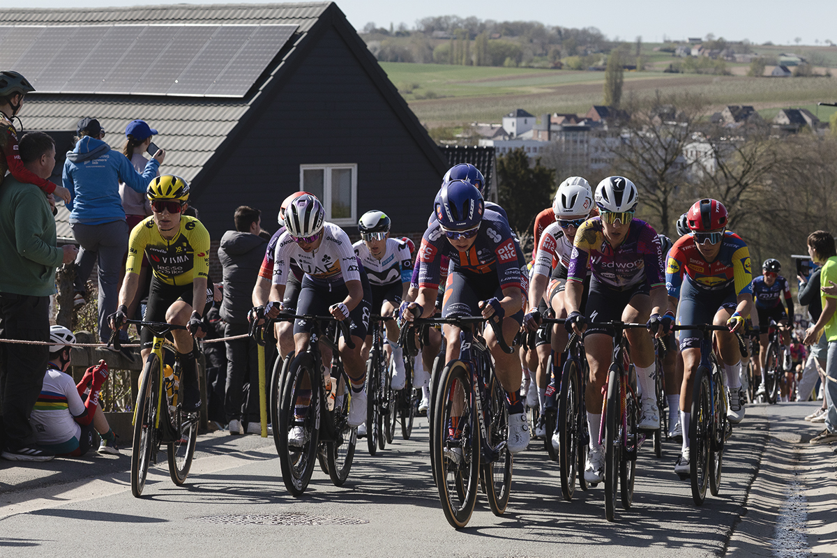 Ronde van Vlaanderen Vrouwen 2025 - Riders on Berendries the town and Belgian countryside in the distance